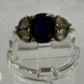Jewellery: Hallmarked 9ct gold ring set with an oval blue paste, two pear-shaped white paste either 