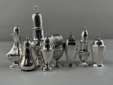 Silver: a group of seven pepperettes of various designs, makers and dates, together with a baluster 
