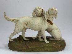 A Royal Dux figure group of two gun dogs, 1st half 20th century, one standing with tail erect, the o