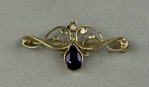 Jewellery: 9ct gold open scroll brooch set with a brilliant-cut diamond, estimated weight 0.03ct and