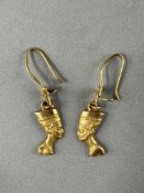 Jewellery: Pair of yellow metal drop earrings with a female Egyptian-style head having safety wire f