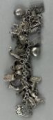 Jewellery:Sterling marked white metal curb-link bracelet with more than 30 charms attached; surface 
