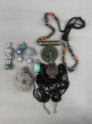 Jewellery: a South American white metal malachite set figural pendant, a pair of silver mounted turq
