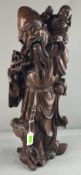 A Chinese mid century rootwood carving of Shou Lao, a small child on his shoulder, 53cm.