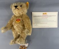 Toys: a Steiff blonde mohair teddy bear, 30cm, complete with original labels, leaflet and box.