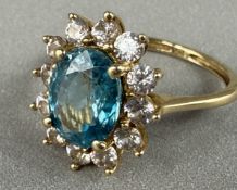 Jewellery: a yellow metal cluster ring, a central topaz within a halo of white spinel, UK size M, 3.
