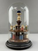Sewing Accessories: a 19th century two tier cotton reel holder, a central integral turned thimble ho