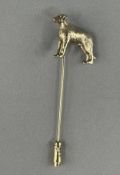Jewellery: Yellow metal stick pin terminated with the figure of a dog, indistinctly marked, surface 