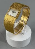 Watches: a ladies 9ct gold cased rectangular faced wristwatch by Beuche Girod, London 1975, on integ