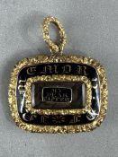 Jewellery: a 19th century yellow metal and enamel mourning pendant, testing as 15ct gold, the centre