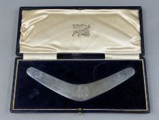 Silver: an Australian novelty letter opener of boomerang form by JM Dempster Ltd, engraved with the 