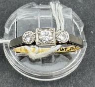 Jewellery: Yellow metal ring, set in white metal, with three graduated diamonds, estimated weight of