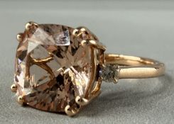 Jewellery: a rose coloured metal ring, marked 14k and testing as gold, set a single central Marropin