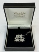 Jewellery: White metal double love bow brooch set with one hundred and fifty round-cut diamonds, est