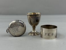 Silver: Three hallmarked silver items to include an eggcup, a napkin ring and a circular vesta case 