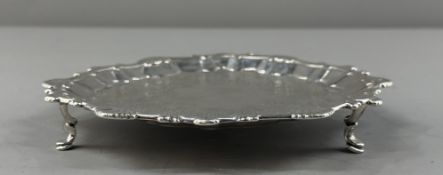 Silver: a card tray of Rococo form, London 1762, the rim cast with shells and beads, the centre late