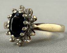 Jewellery: a 9ct yellow gold cluster ring set an oval Australian sapphire within a halo of claw set 