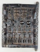 Ethnographica: a carved Dogon granary door, Mali, stylistically carved in high relief with figures, 