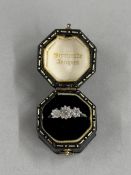 Jewellery: a yellow metal ring with three graduated Edwardian brilliant-cut diamonds, set in white m