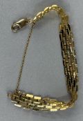 Jewellery: a yellow metal brick effect bracelet, marked 375 and testing as gold, c.19cm long not inc