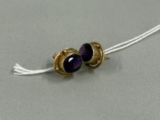 Jewellery: a pair of 9ct yellow gold and amethyst earrings for pierced ears, the stone raised within