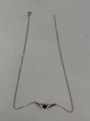 Jewellery: a 9ct yellow gold butterfly style necklace, set a central sapphire flanked by a small dia