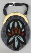 Fashion: an early 20th century beaded handbag with simulated ivory mount, decorated in blues, greens