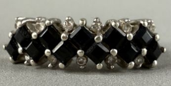 Jewellery: a 9ct white gold ring set with 11 square cut Australian sapphires, flanked by 11 small di