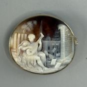 Jewellery: a yellow metal mounted cameo, marked 9ct and testing as gold, carved as a young man playi