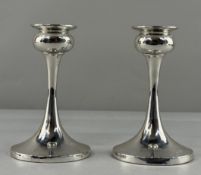 Hallmarked Silver: a pair of Modernist filled candlesticks on a 92mm circular foot with a garlic top