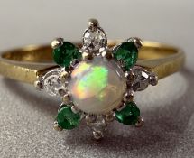 Jewellery: 9ct gold floral cluster ring centre set with a circular cabochon-cut opal, estimated weig