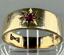 Jewellery: a 9ct yellow gold tapering wedding band set a single ruby, UK size Q, weight 3.8g.