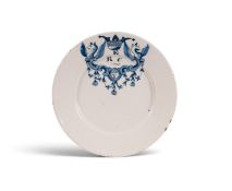 A Delft marriage plate, dated 1690, painted in blue with two winged griffins flanking a cartouche in