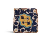 A Safavid cuerda seca tile, 16th/17th century Persia, the square form decorated with a cobalt blue m