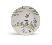 A large London delftware charger, c.1740, painted in blue, red, green and yellow with a large bird d