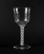 A large wine glass or goblet, c.1760, the generous ogee bowl with dimpled moulding, raised on a doub