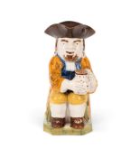 A Pratt ware Toby jug, c.1790-1800, of Ordinary type, seated with a patterned jug of ale, wearing an