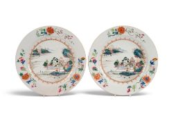 A pair of Chinese famille rose chargers, Qianlong 1736-95, painted with figures on a bridge within a