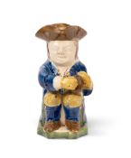 A Pratt ware 'Askew' Toby jug, c.1810, traditionally modelled and raised on a green chamfered base, 