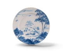 A Bristol delftware plate, c.1760, painted in blue with a shepherd and companion tending a flock of 