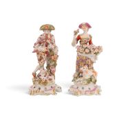 A pair of Bow figures of a shepherd and his companion, c.1765, he playing the flageolet with a dog r