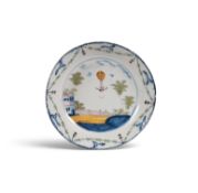 A rare Lambeth delftware commemorative 'ballooning' dish, c.1785, painted in blue, green, yellow and