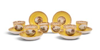 Six Derby yellow-ground tea cups and saucers, c.1800, painted with landscape roundels attributed to 