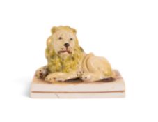 A Staffordshire figure of a lion, c.1820, probably Wood and Caldwell, recumbent on a rectangular bas
