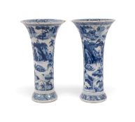 A pair of Chinese blue and white sleeve vases, Kangxi 1662-1722, painted with figures in continuous 