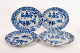 Four Chinese blue and white oval chargers or serving dishes, 18th/19th century, painted with Chinese