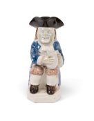 A rare Wood type double-based Toby jug, c.1785-95, wearing a blue coat, his breeches washed in manga