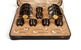A Royal Worcester cased coffee set, date codes for 1929, decorated with simple gilt foliate stripes 