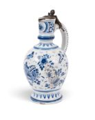A Delft pewter-mounted jug or ewer, c.1720, painted in blue with a bird perched above flowering plan