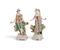 A pair of Derby figures of dancers, c.1760-65, each holding a small posy of flowers and standing bef